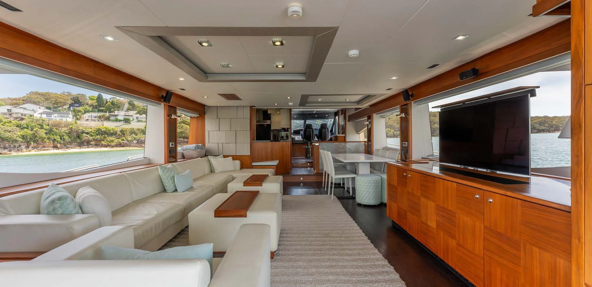 a living room with a large television aboard SYDNEY Yacht for Charter