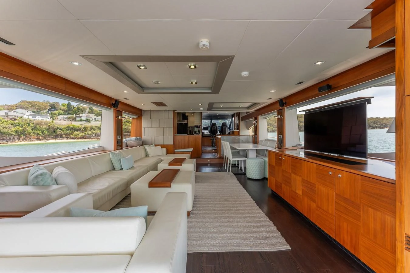 a living room with a large screen aboard SYDNEY Yacht for Charter