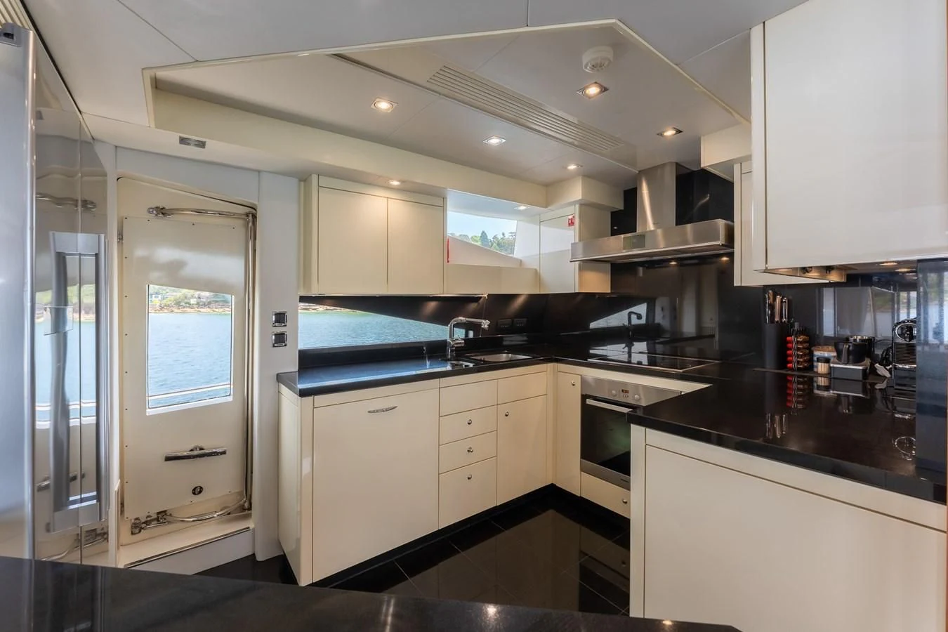 a kitchen with white cabinets aboard SYDNEY Yacht for Charter