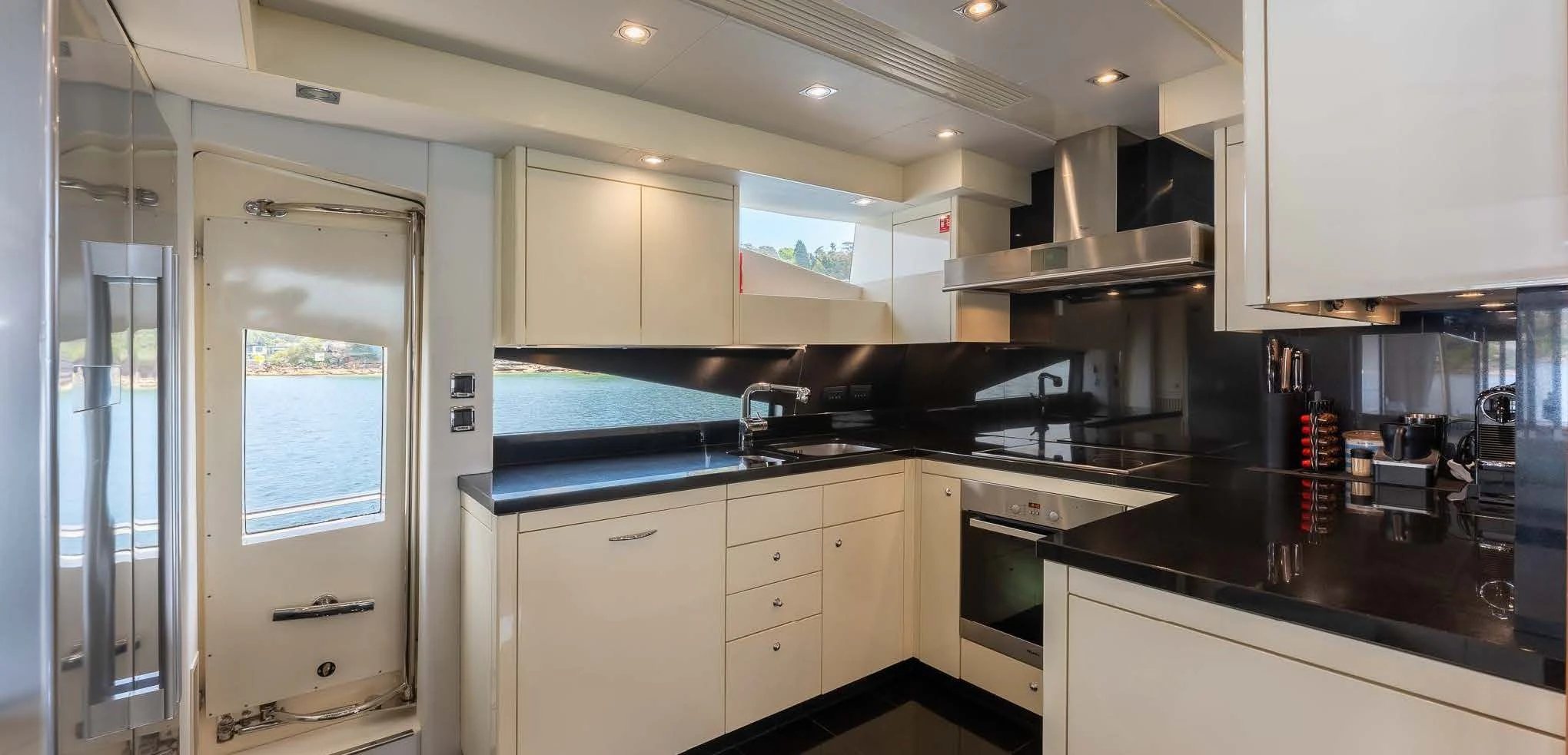 a kitchen with white cabinets aboard SYDNEY Yacht for Charter