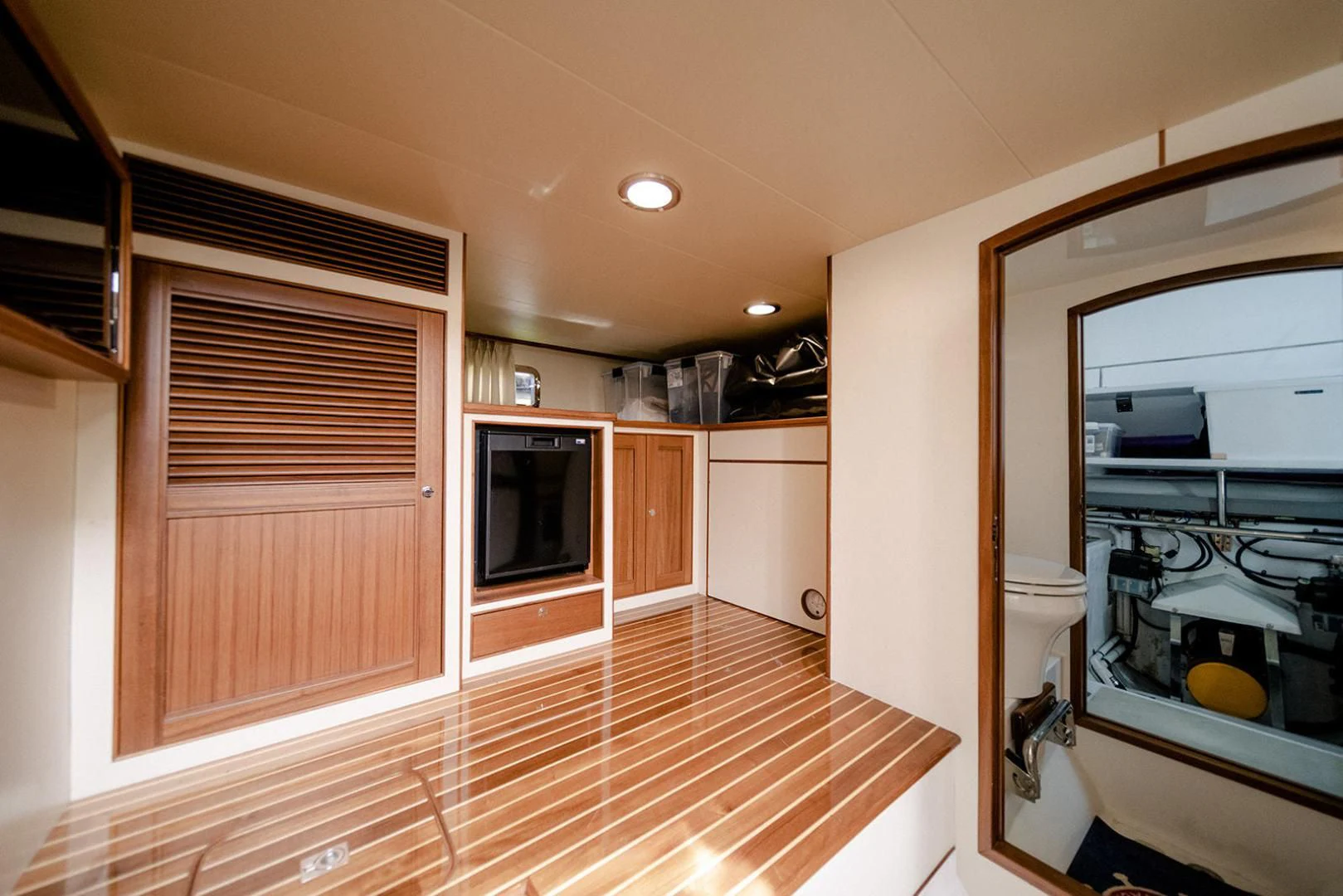 a room with a wood floor and a wood floor and a mirror aboard EASYWAY Yacht for Sale