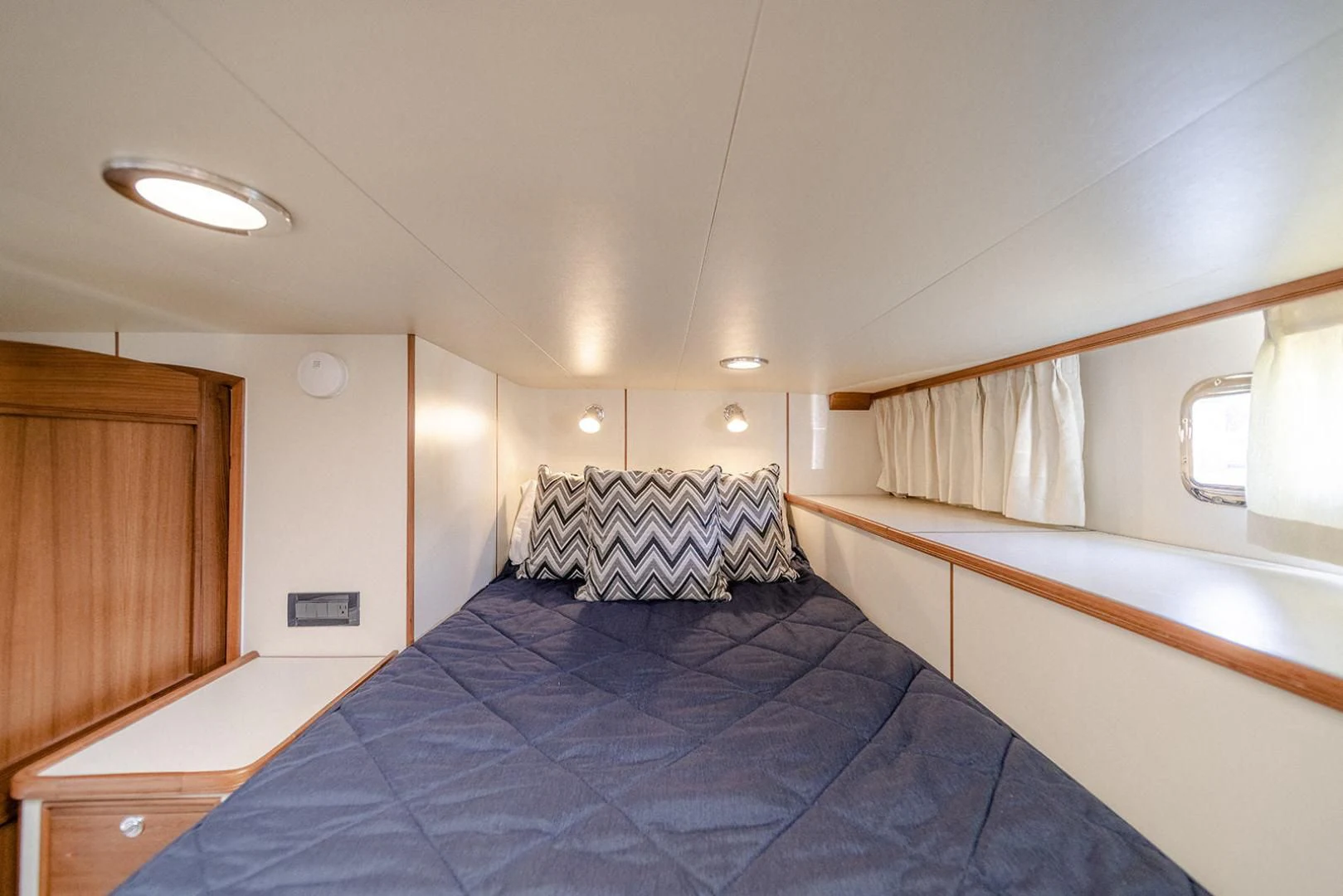 a bedroom with a bed and a mirror aboard EASYWAY Yacht for Sale