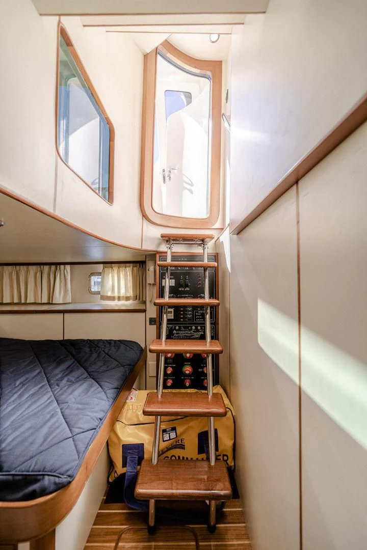 a bed and a desk in a room aboard EASYWAY Yacht for Sale