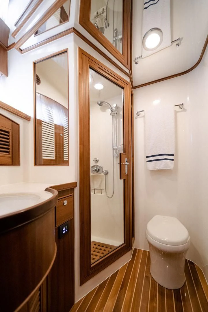 a bathroom with a shower and toilet aboard EASYWAY Yacht for Sale