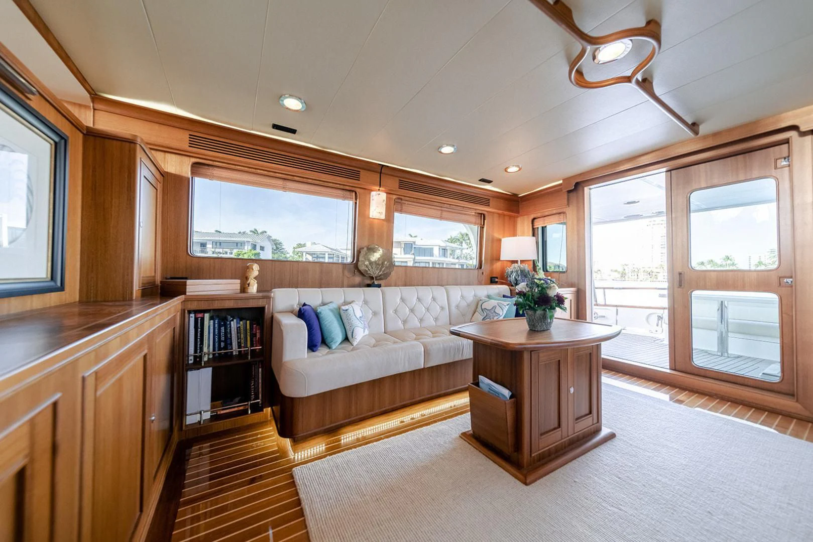 a large living room with a large window and a wood table aboard EASYWAY Yacht for Sale