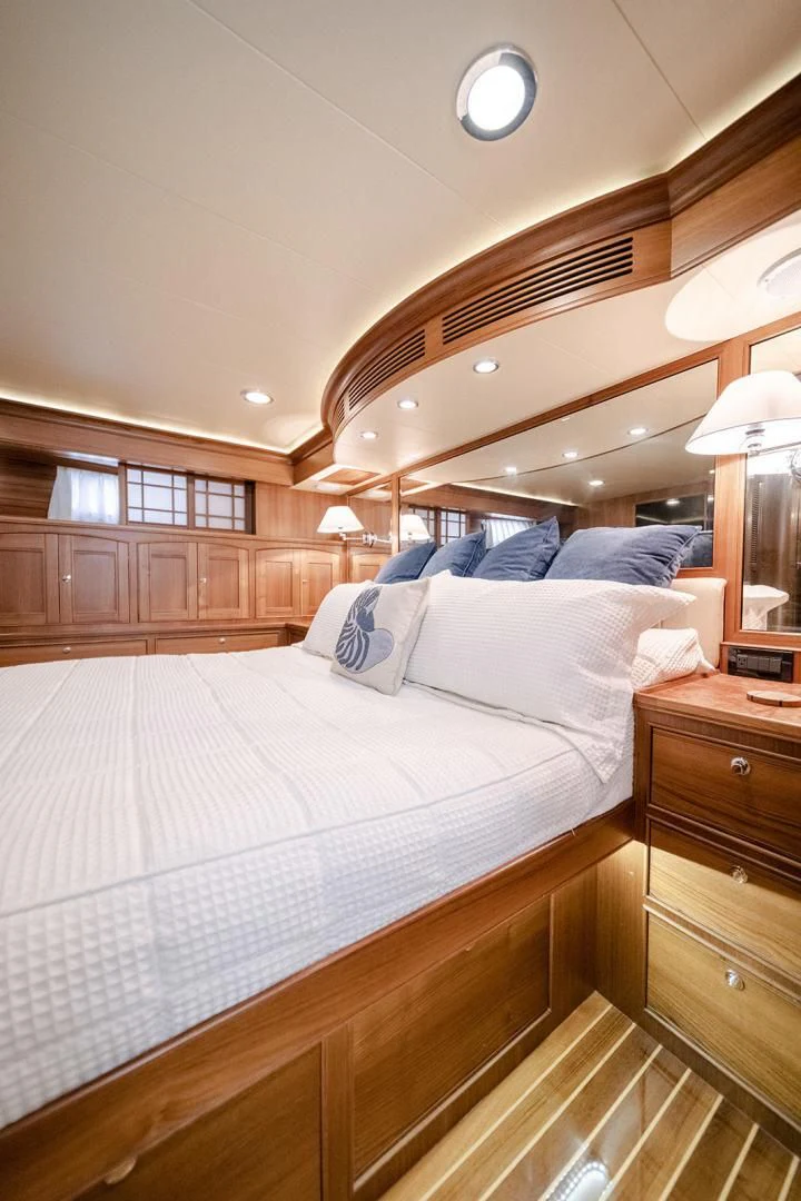 a bed with a white comforter aboard EASYWAY Yacht for Sale