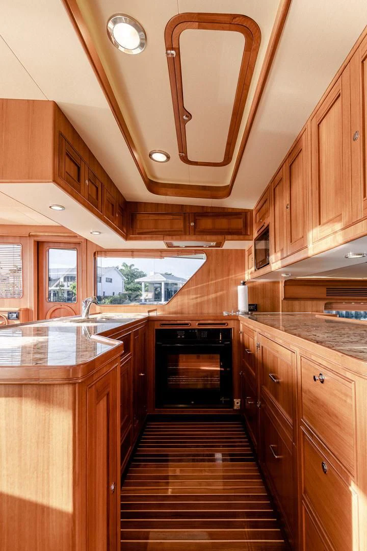 a kitchen with wooden cabinets aboard EASYWAY Yacht for Sale