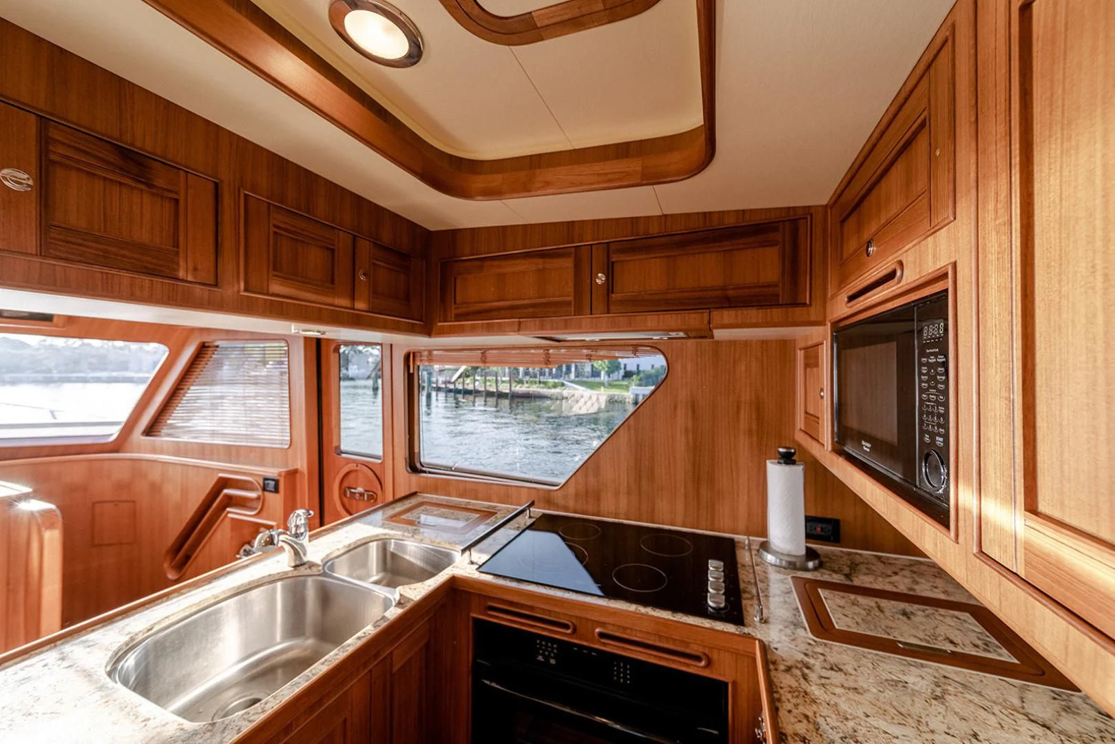 a kitchen with wooden cabinets aboard EASYWAY Yacht for Sale