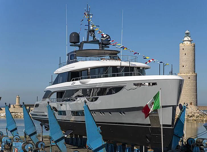 a large white boat with flags aboard JOY Yacht for Sale