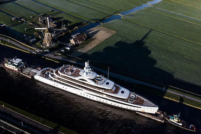 a large ship in a harbor aboard DEFY Yacht for Sale