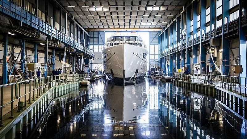 a large white ship in a large building aboard DEFY Yacht for Sale