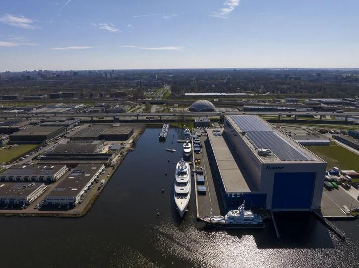 a building with a parking lot aboard DEFY Yacht for Sale