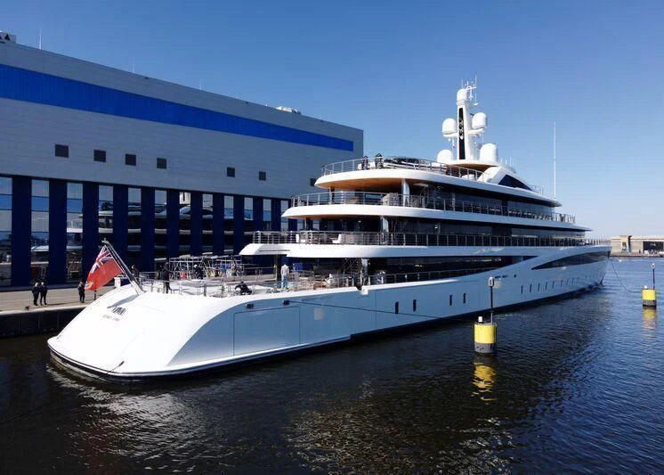 a large cruise ship docked aboard DEFY Yacht for Sale