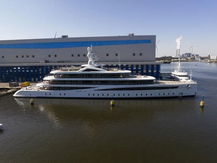 a large cruise ship docked aboard DEFY Yacht for Sale