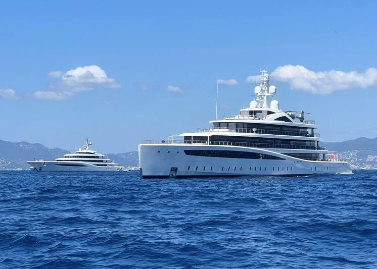 a couple of large white boats in the water aboard DEFY Yacht for Sale
