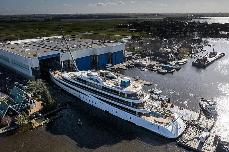 a large ship docked at a port aboard DEFY Yacht for Sale