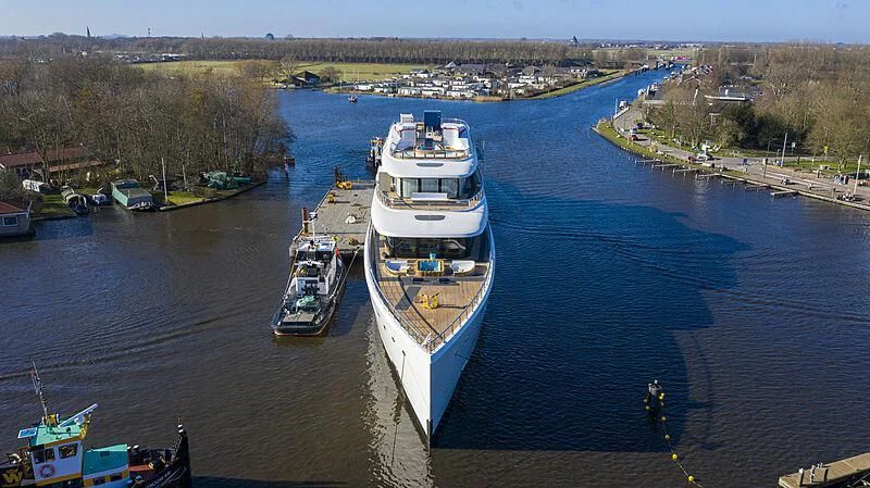a large ship in the water aboard DEFY Yacht for Sale