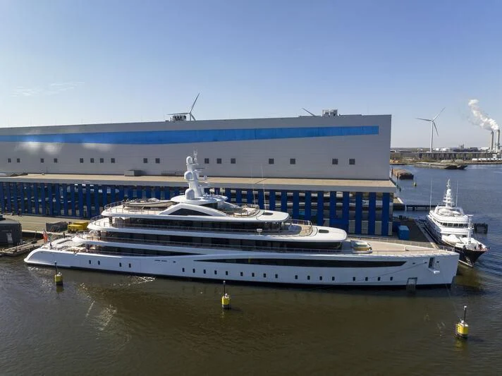 a large cruise ship docked aboard DEFY Yacht for Sale