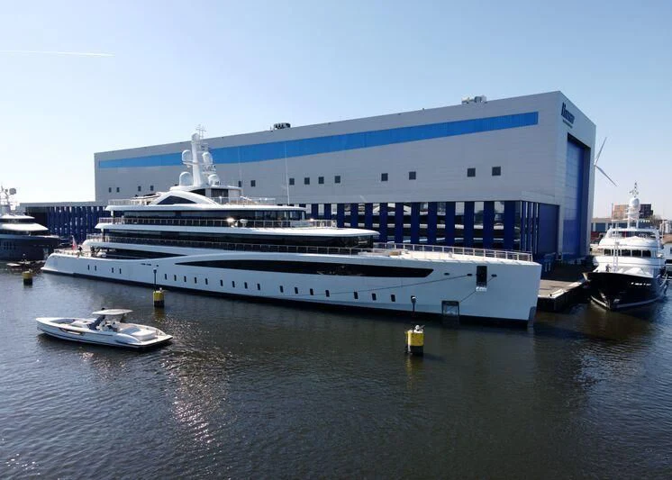 a large cruise ship docked aboard DEFY Yacht for Sale