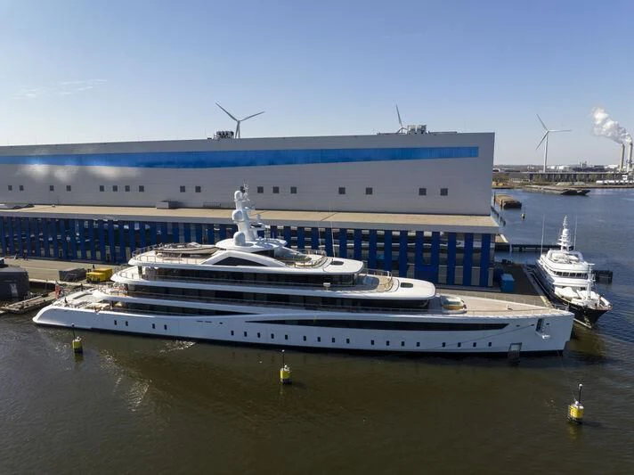 a large cruise ship docked aboard DEFY Yacht for Sale