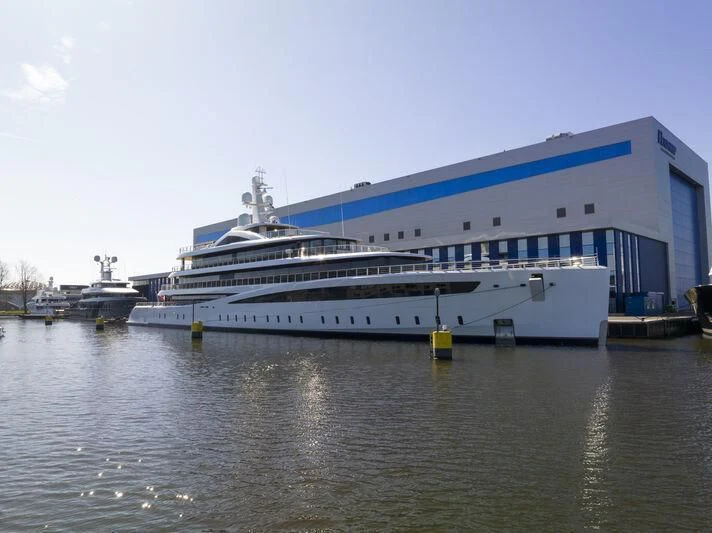 a large cruise ship docked aboard DEFY Yacht for Sale