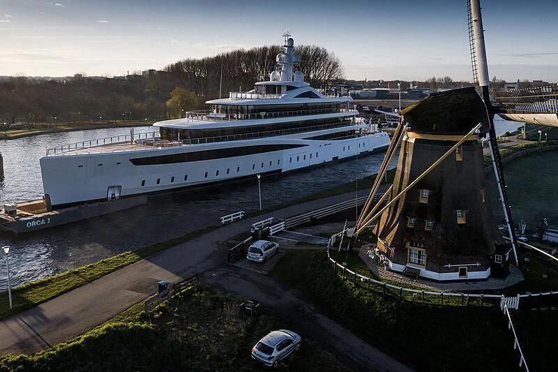 a large cruise ship docked aboard DEFY Yacht for Sale