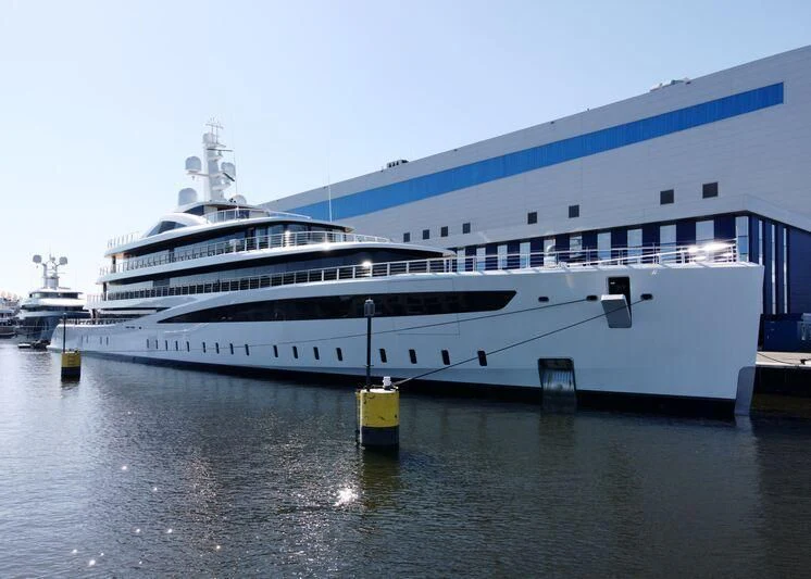 a large cruise ship docked aboard DEFY Yacht for Sale