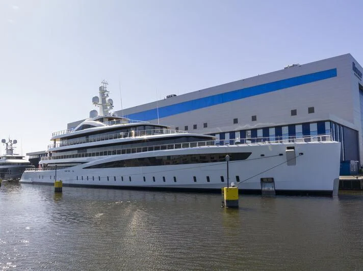 a large cruise ship docked aboard DEFY Yacht for Sale