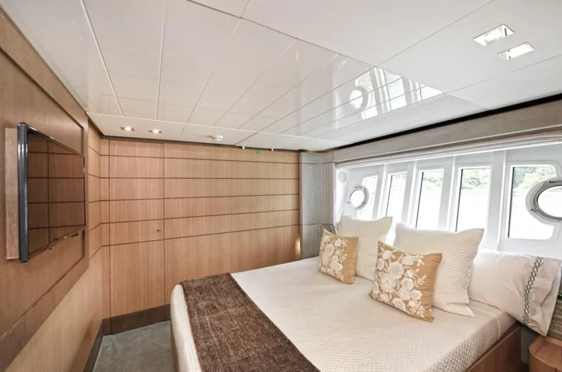 a room with a bed and a window aboard IN TOO DEEP Yacht for Sale
