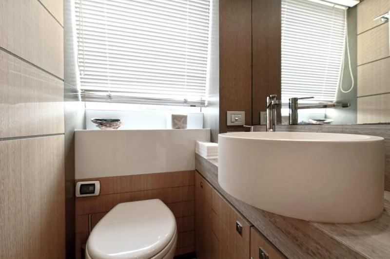 a bathroom with a tub sink and toilet aboard IN TOO DEEP Yacht for Sale