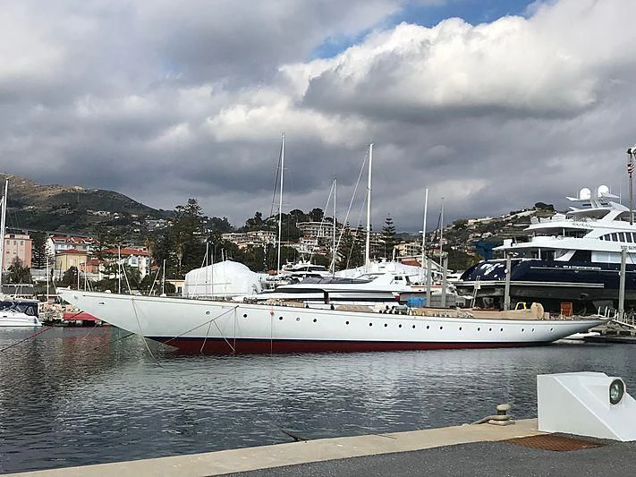 a large white boat sits in a harbor aboard ELENA OF LONDON Yacht for Sale