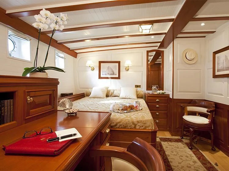 a living room with a couch and a table aboard ELENA OF LONDON Yacht for Sale