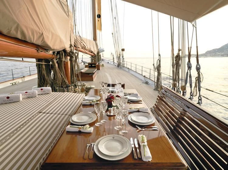 a table set for a dinner party aboard ELENA OF LONDON Yacht for Sale