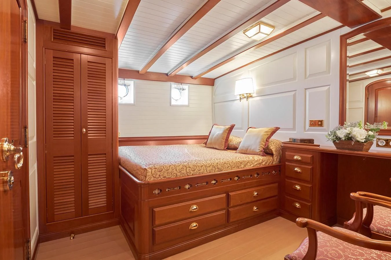 a bedroom with a bed and a desk aboard ELENA OF LONDON Yacht for Sale