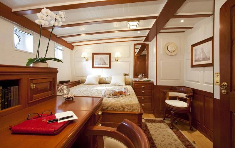 a living room with a couch and a table aboard ELENA OF LONDON Yacht for Sale