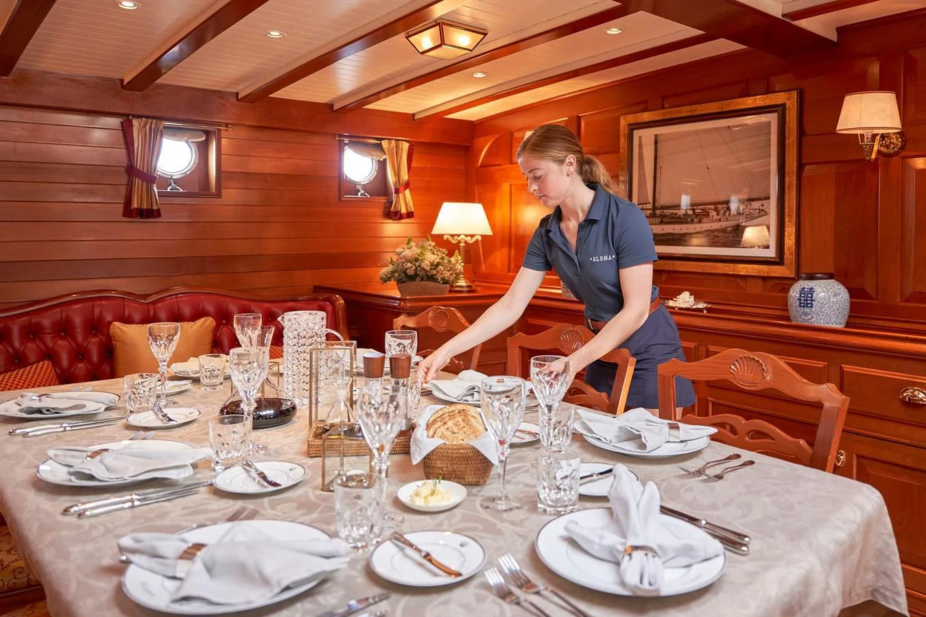 a couple of women sitting at a table with plates and glasses aboard ELENA OF LONDON Yacht for Sale