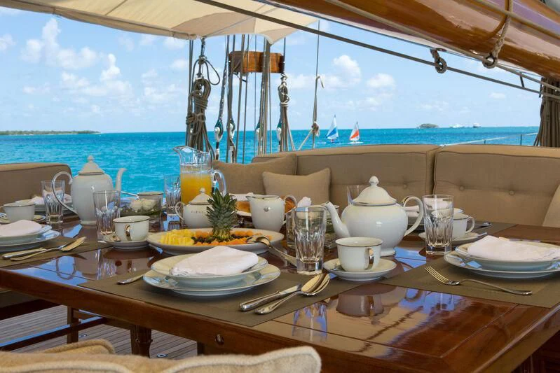 a table with plates and glasses on it aboard ELENA OF LONDON Yacht for Sale