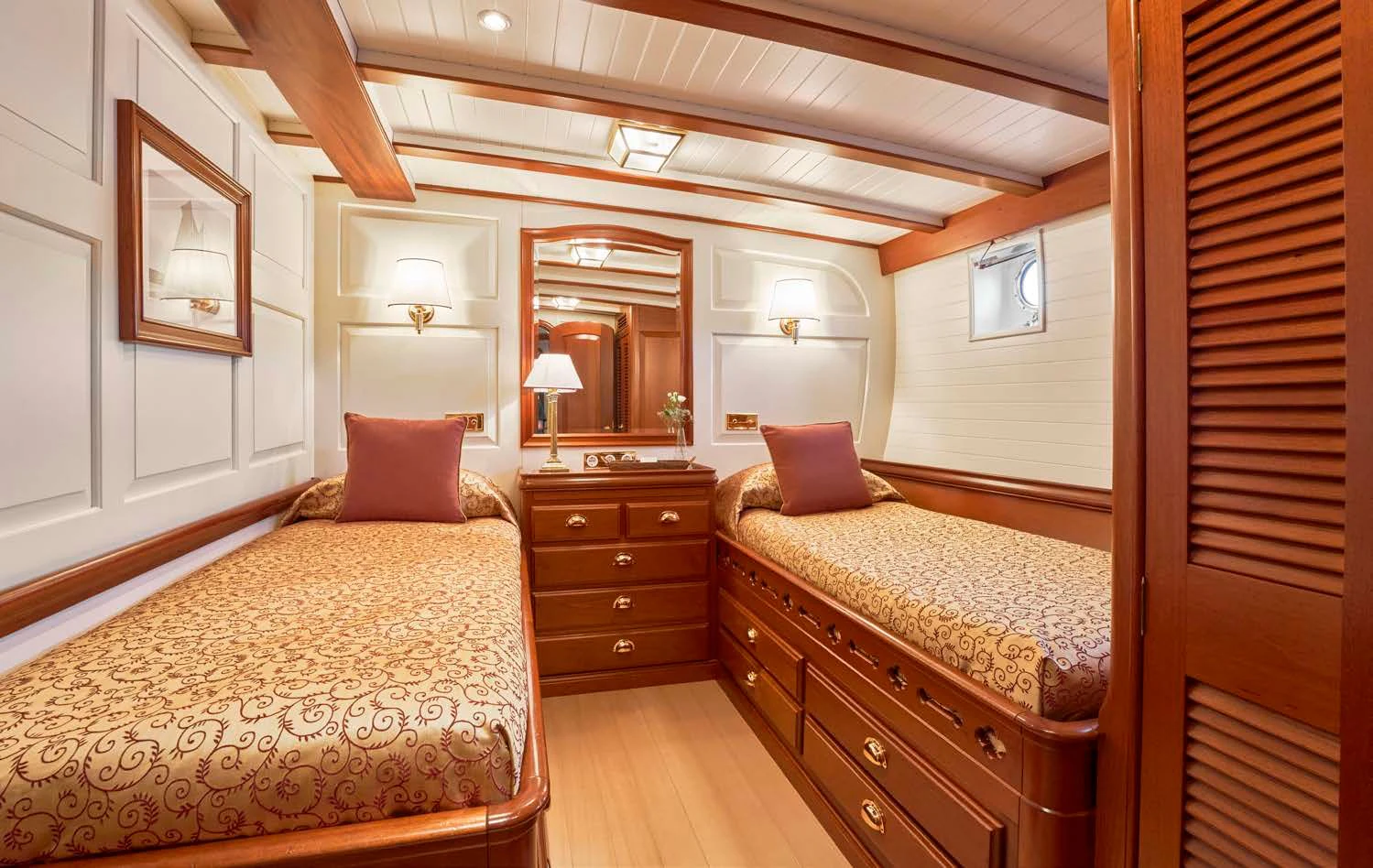 a bedroom with a bed and a dresser aboard ELENA OF LONDON Yacht for Sale
