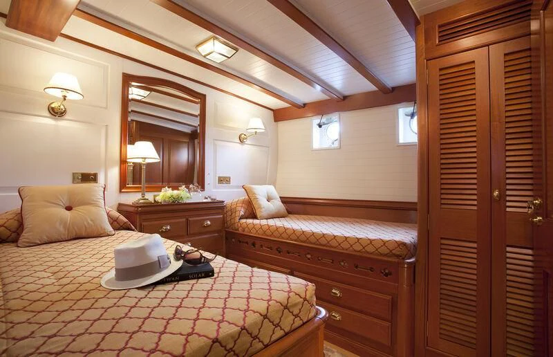 a bedroom with a bed and a laptop on the bed aboard ELENA OF LONDON Yacht for Sale
