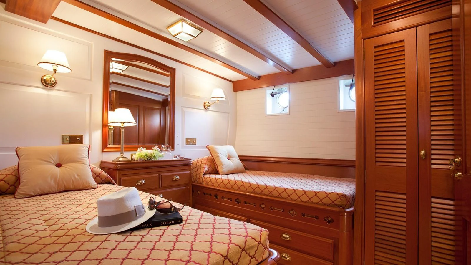 a hotel room with a bed and a laptop aboard ELENA OF LONDON Yacht for Sale