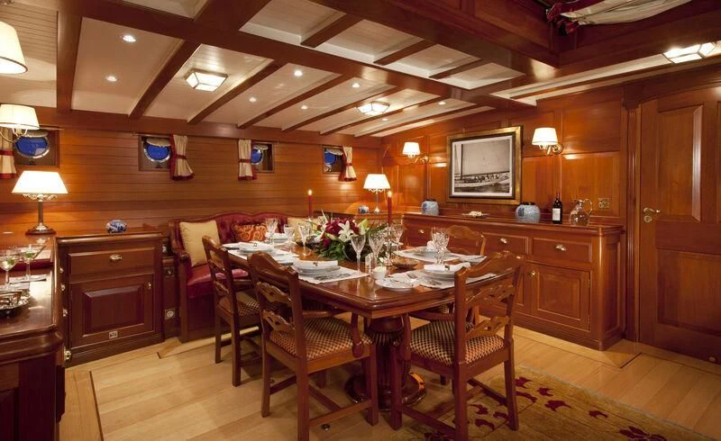 a dining room with a table and chairs aboard ELENA OF LONDON Yacht for Sale