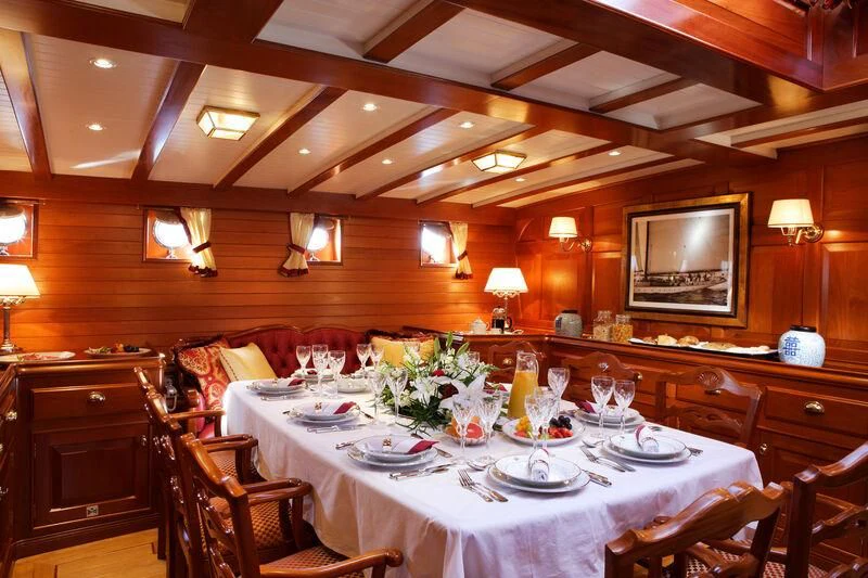a large room with tables and chairs aboard ELENA OF LONDON Yacht for Sale