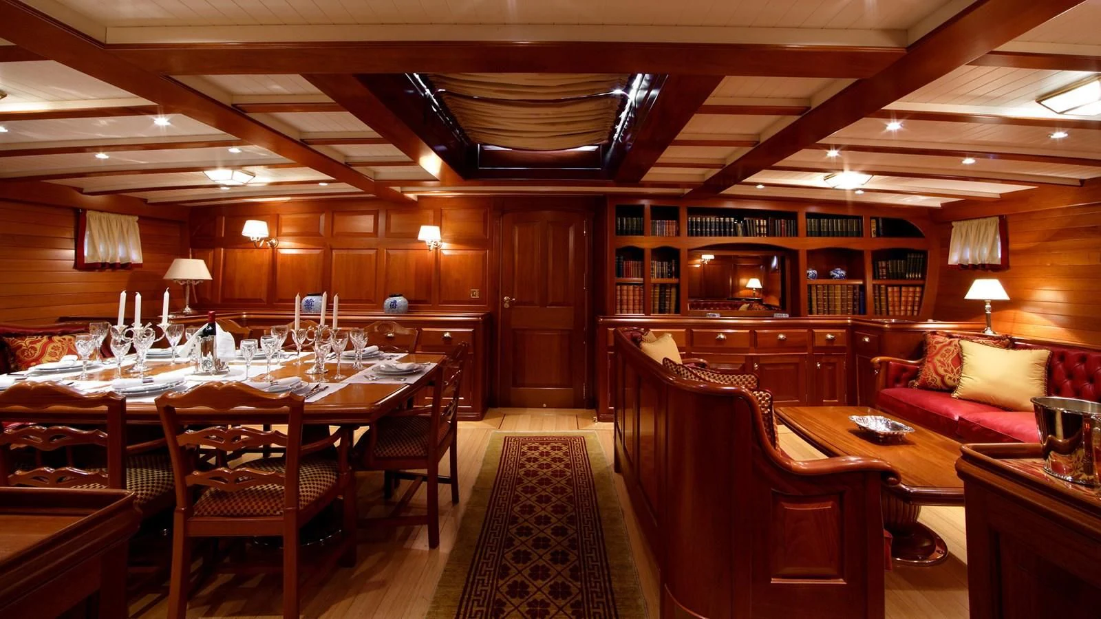 a large room with a table and chairs aboard ELENA OF LONDON Yacht for Sale