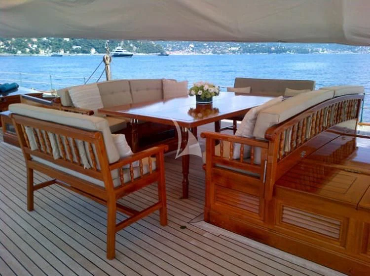 a table and chairs on a deck aboard ELENA OF LONDON Yacht for Sale