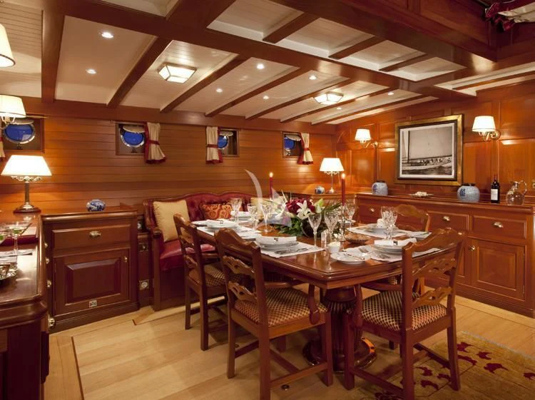 a dining room with a table and chairs aboard ELENA OF LONDON Yacht for Sale
