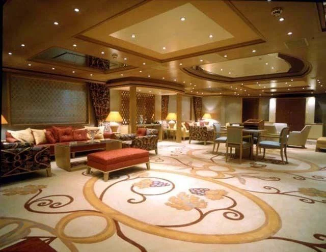 a large living room with a large chandelier aboard CONSTELLATION Yacht for Sale