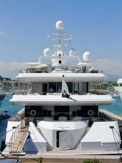 a large white boat with a group of people on it aboard CONSTELLATION Yacht for Sale