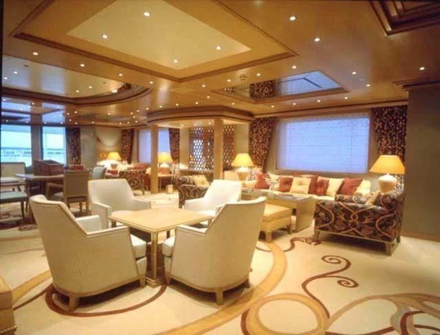 a large living room with a large window aboard CONSTELLATION Yacht for Sale