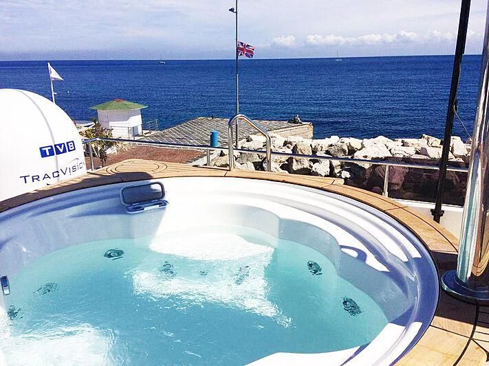 a large blue pool with a flag on top of it aboard PALGREMAT Yacht for Sale