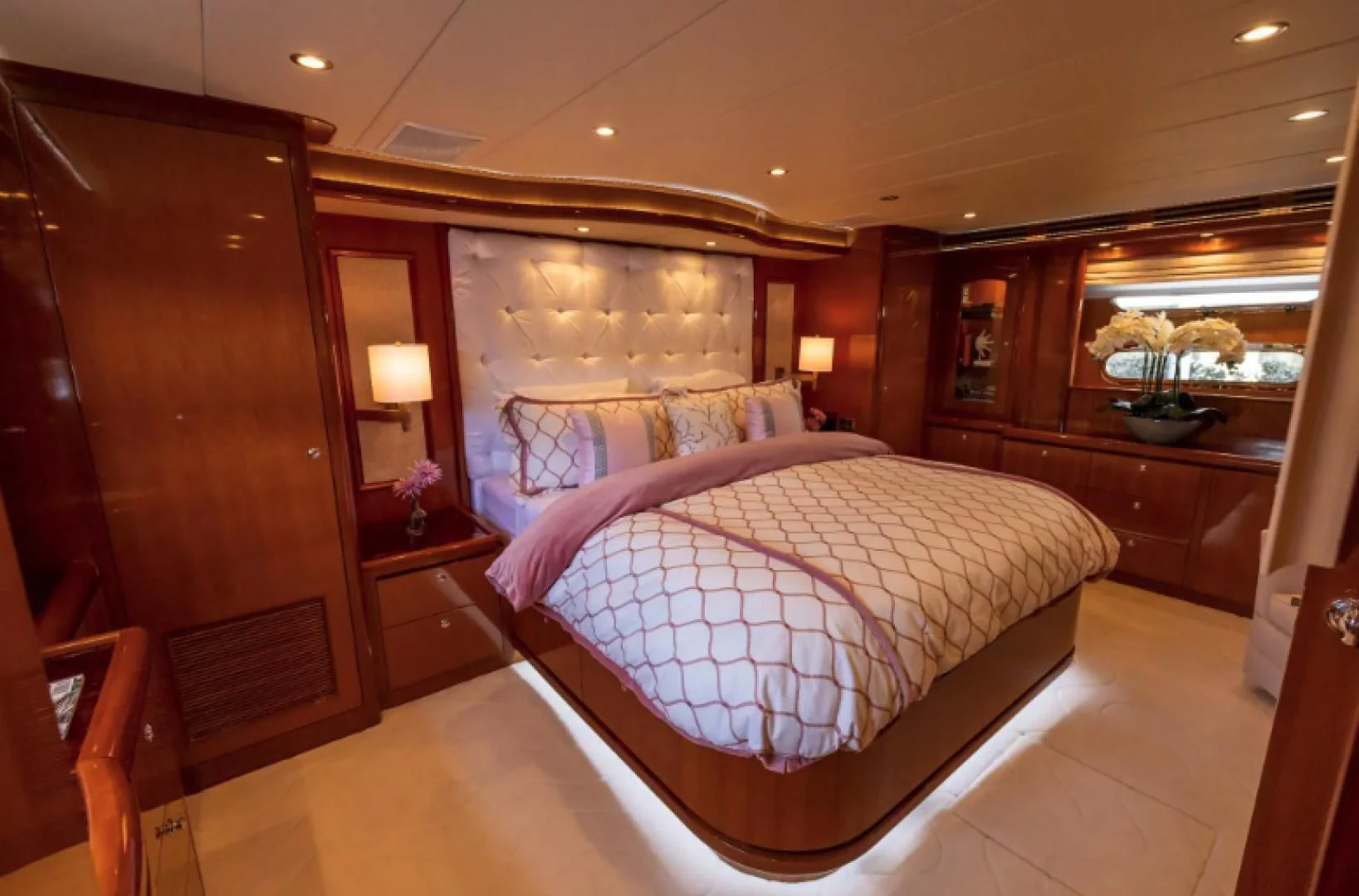 a bedroom with a bed and a mirror aboard WRITE SOON Yacht for Sale
